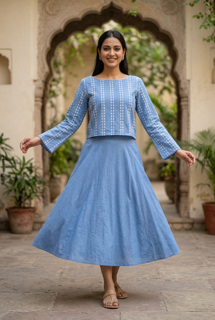 Twirl pose with the blue cotton skirt and boat-neck embroidered crop top